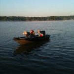 tracker aluminum bass fishing boat mist on the lake water